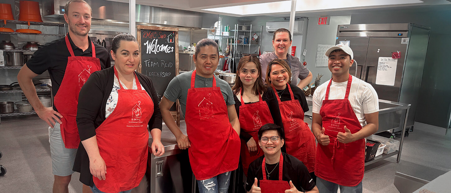 Volunteers gather for a photo in the kitchen