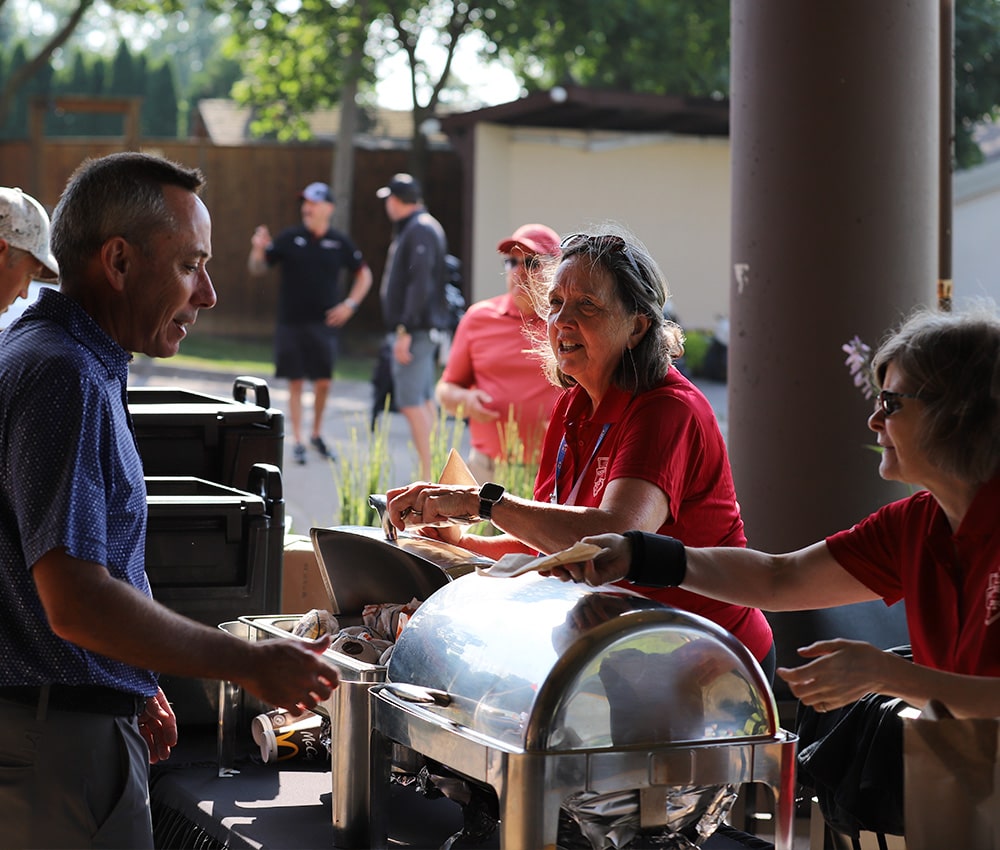 Event team serving breakfast to event participants