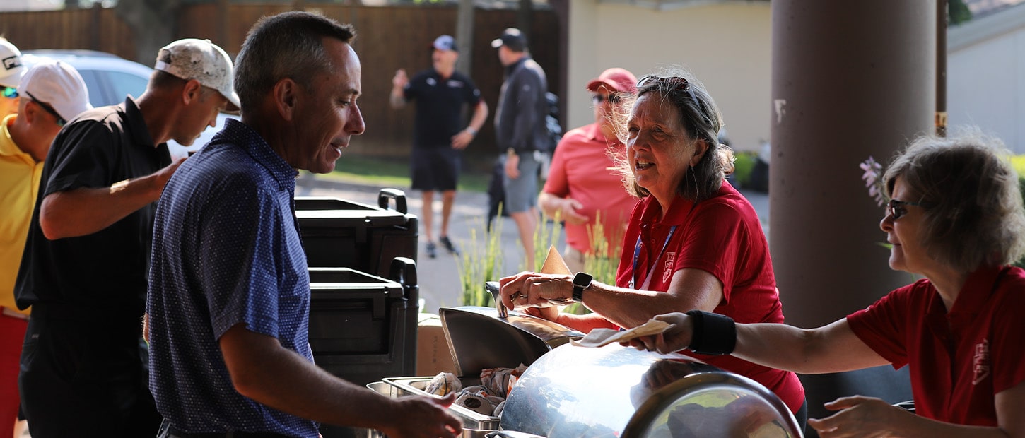 Event team serving breakfast to event participants