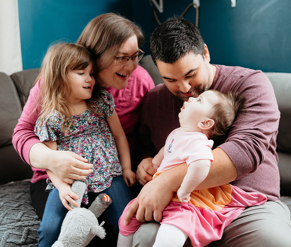 Family sit together on couch