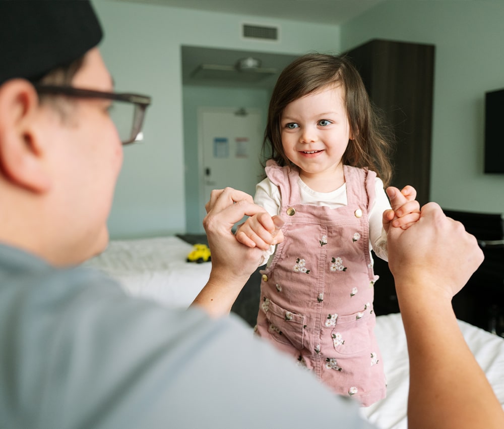 Child plays with family in a room